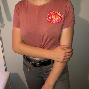 pink crop top w a painted flower on it